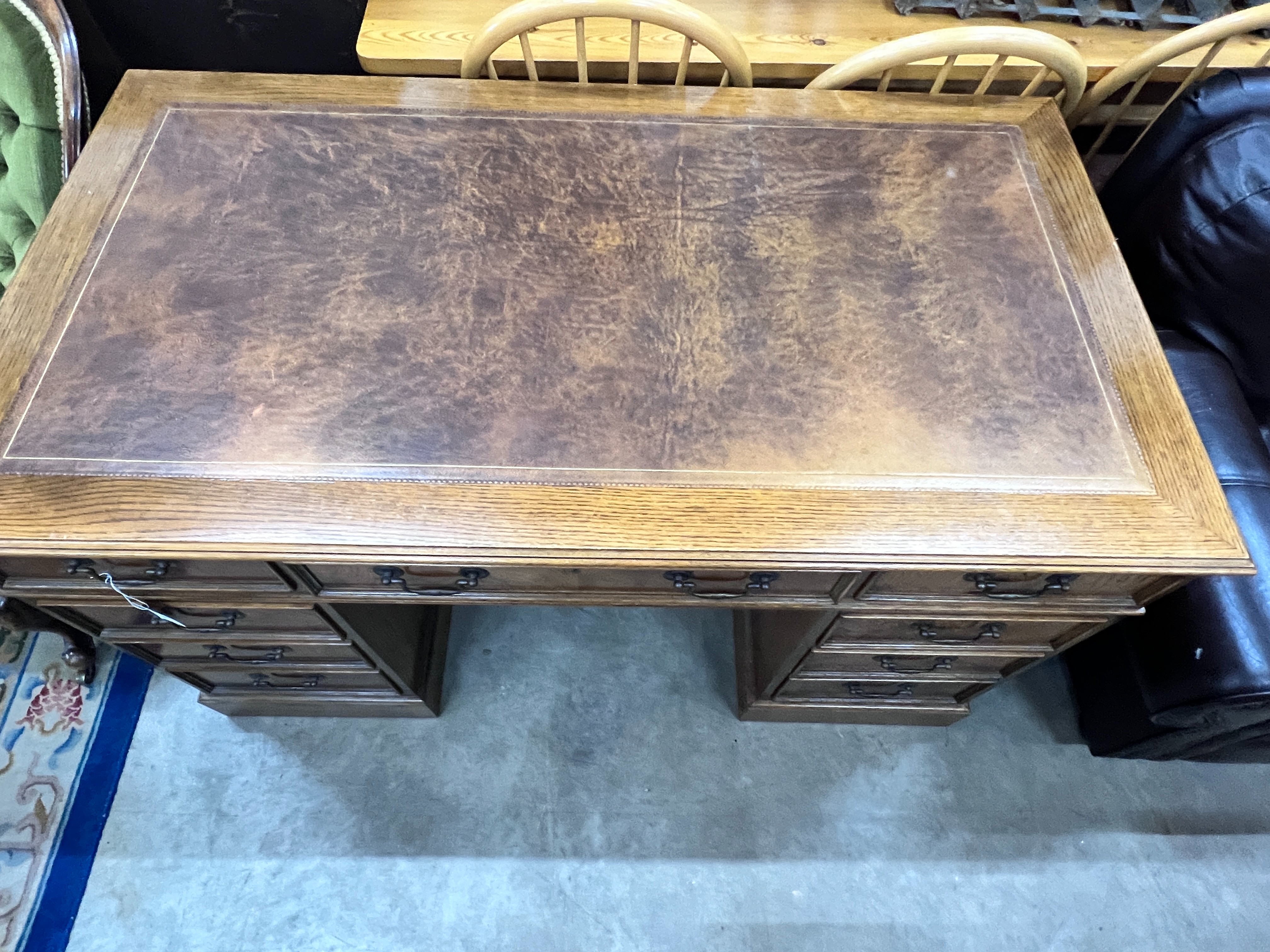 A good quality reproduction Victorian style oak pedestal desk, length 137cm, depth 76cm, height 79cm